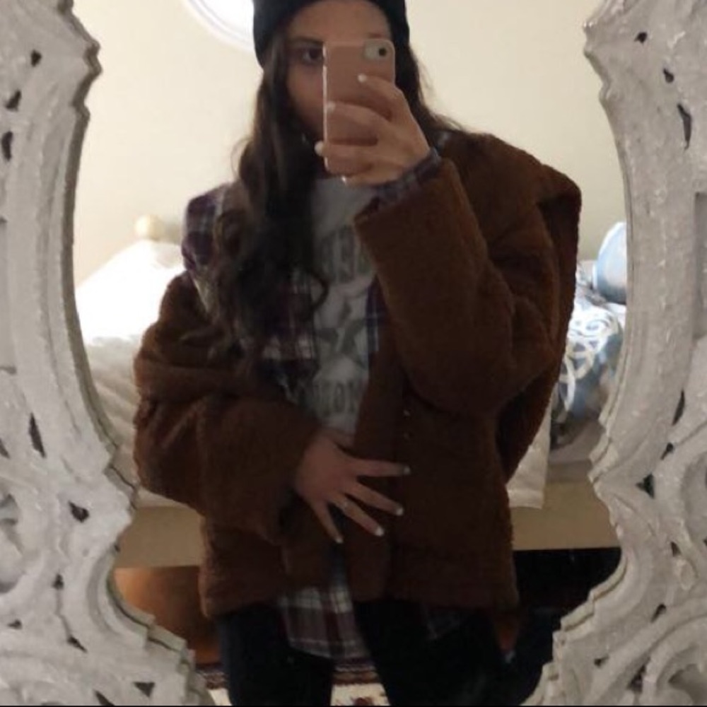 Brown fuzzy coat. No zipper. Very comfy and warm.